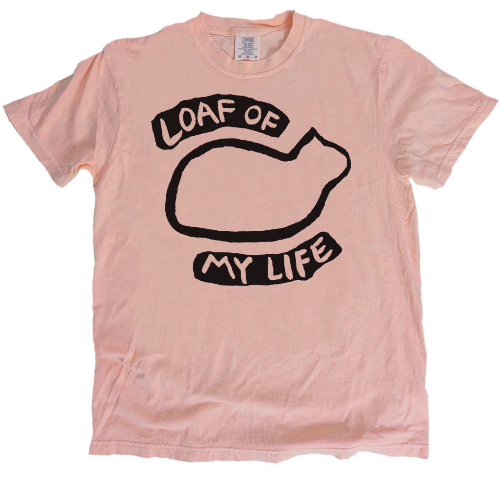 Pink t-shirt with black graphic and text 'Loaf of My Life' on a white background