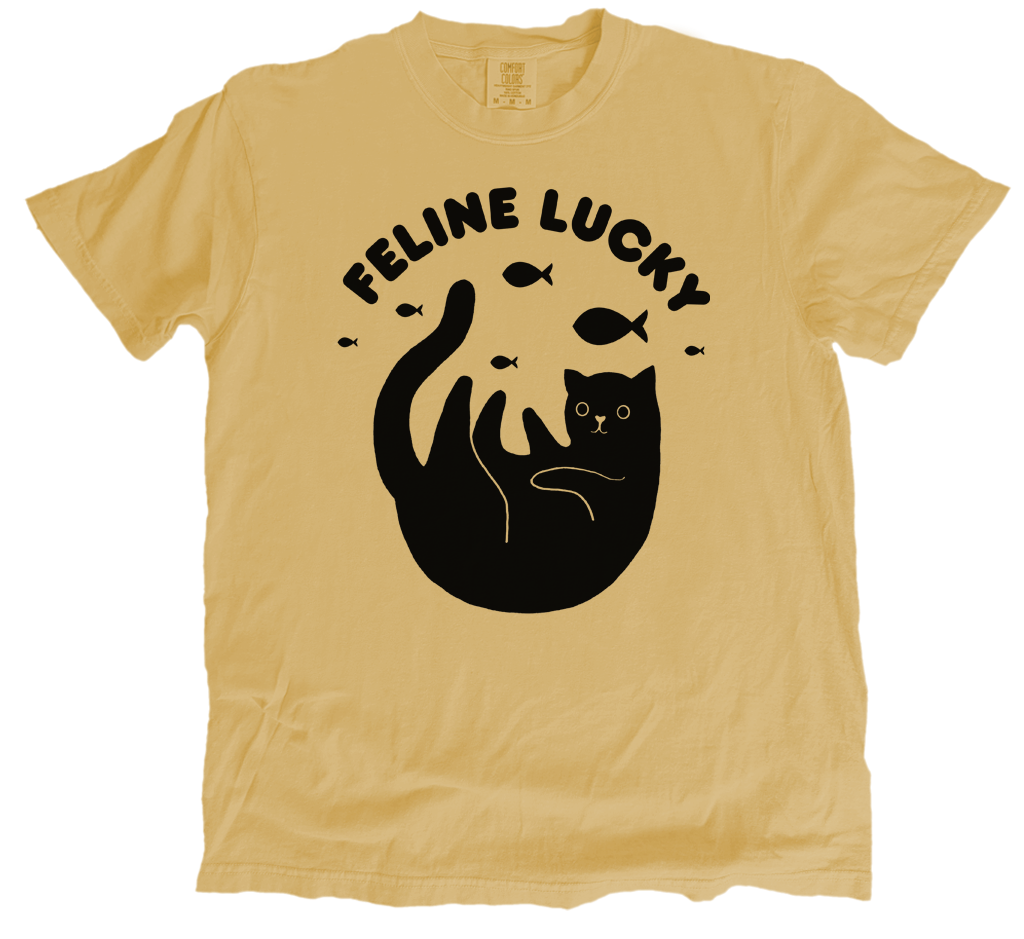 mustard yellow t-shirt with black graphic and 'Feline Lucky' text on a white background