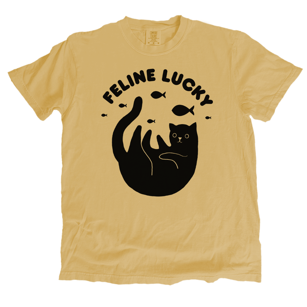mustard yellow t-shirt with black graphic and 'Feline Lucky' text on a white background