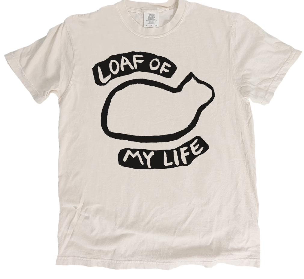 White t-shirt with black graphic and text 'Loaf of My Life' on a white background