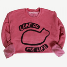 red sweatshirt with black cat loaf graphic and text on a white background