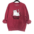 Red sweatshirt with a cat graphic and 'Be Mine, Feline' text on a white background