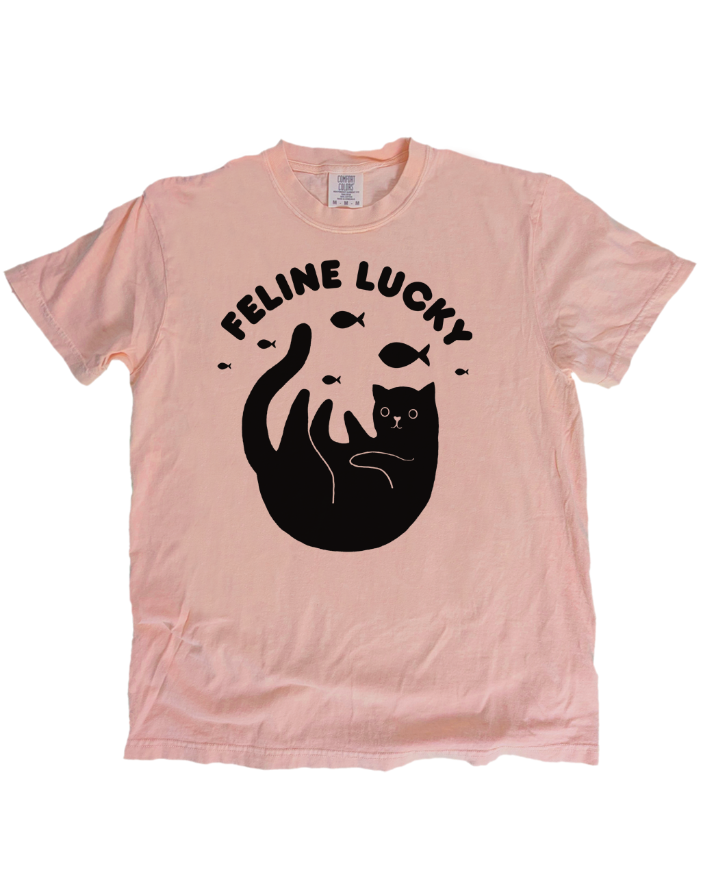 Pink t-shirt with black cat graphic and 'Feline Lucky' text on a white background