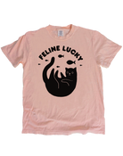 Pink t-shirt with black cat graphic and 'Feline Lucky' text on a white background