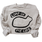 Beige sweatshirt with black graphic and text 'LOAF OF MY LIFE' on a white background